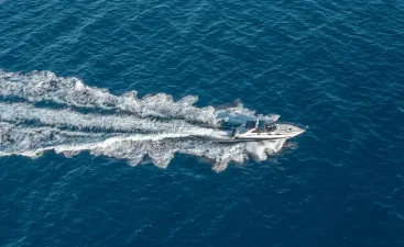 Boat speeding across the water with boat accessories on it