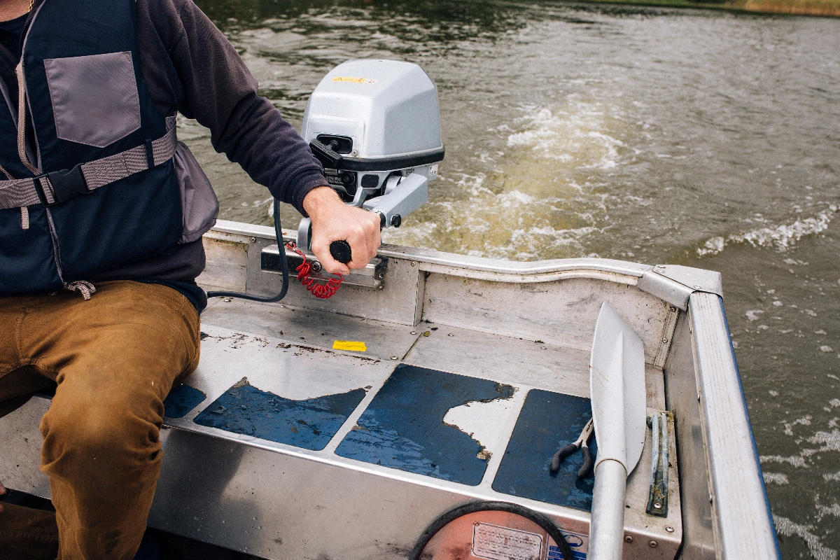 Man using boat hydraulic steering system