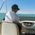 Man steering a boat in a low-back boat seat