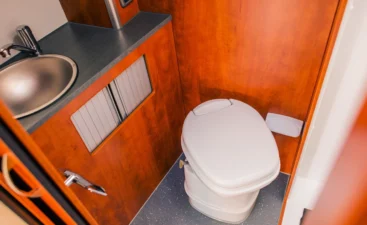 modern-rv-bathroom-interior-with-sink-and-toilet-2026-01-08-22-52-19-utc A compact toilet in a small bathroom