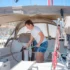 Woman washing boat with onboard water supply, pressurised with a water pump